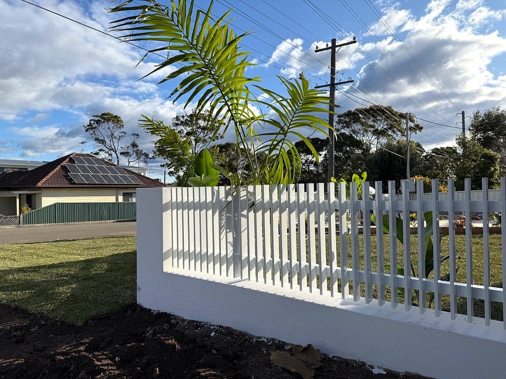 Stepped white aluminium fencing